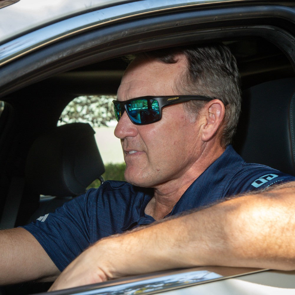 Dan Jansen driving a car while wearing Jansen sunglasses, embodying performance and lifestyle.